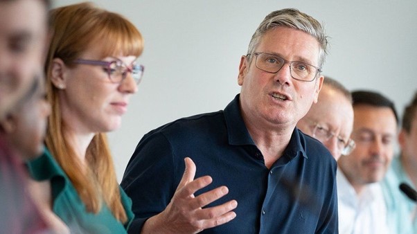 Keir Starmer speaks at the NPF meeting in July, flanked by Deputy Leader Angela Rayner and Shadow Treasury Minister Pat McFadden. BBCPA Media..jpg